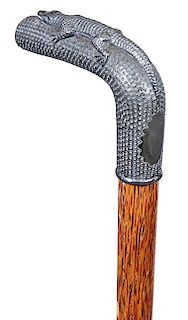 18. Alligator Dress Cane- Ca. 1900- A cast, pewter gator handle, American oak shaft and a metal ferrule. H. - 3 ¾” x 2 ¾