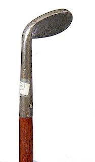 29. Golf System Cane-  Ca 1980- A “Sunday Stick” which has a wedge rather than a putter, mahogany shaft and a metal fer