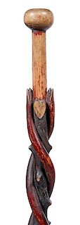 38. Folk Art Snake Cane-  Ca. 1880- A polychrome twin snake cane carved on a natural grown twigspur shaft, a heart and a ca