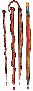 45. Collection of Folk Art Snake Canes- Early 20th Century- A group of four folk art snake canes decorated and carved as se