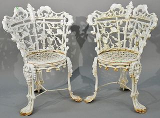 Pair of Victorian iron side chairs having floral and leaf backs with openwork seats. height 32 1/2 inches Provenance: Prop