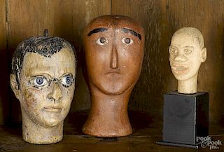 Three carved and painted model heads