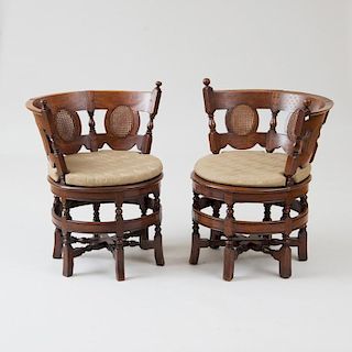 TWO SIMILAR SRI LANKEN SATINWOOD AND CANED BURGERMEISTER CHAIRS