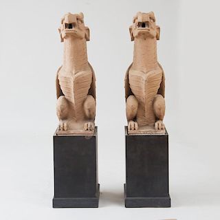 PAIR OF TERRACOTTA-COLORED COMPOSITION WINGED GRIFFIN GARGOYLES