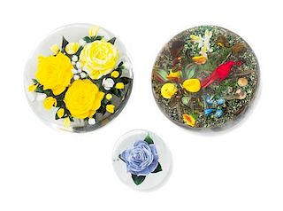* Rick Ayotte, (American), three glass paperweights, each of floral decoration, one including a Summer Tager with ladybug in 