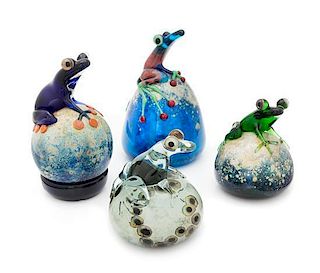 * John Nygren, (American), a group of four paperweights, each with applied frog decoration