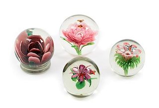 * Four Floral Glass Paperweights  Diameter of largest 3 1/4 inches