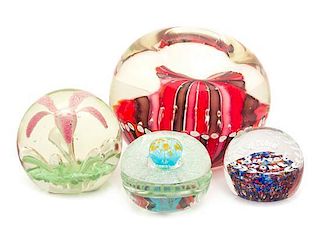 * A Group of Four Glass Paperweights Diameter of largest 8 inches