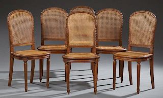 Set of Six French Louis XV Style Carved Oak Dining Chairs, 20th c., the arched caned backs to bowed caned seats on turned tap