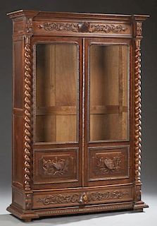 French Henri II Style Carved Oak Bookcase, c. 1880, the stepped breakfront crown with a central relief medallion of artists t