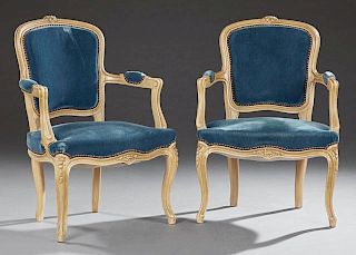 Pair of French Louis XV Style Polychromed Beech Fauteuils, early 20th c., the floral carved arched curved upholstered back ov