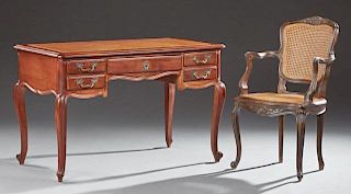 French Louis XV Style Carved Cherry and Beech Desk, 20th c., the stepped rounded edge and corner top with an inset gilt toole