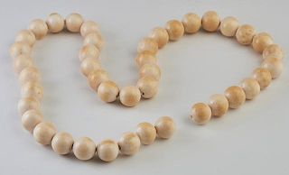 African Carved Ivory Ball Necklace, mid 20th c., composed of forty-two 7/8 in. balls, now lacking a clasp, L.- 35 in.