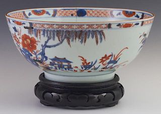 Chinese Imari Style Porcelain Bowl, 19th c., with floral and pagoda decoration, in orange and blue, with an old stapled repai