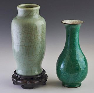 Two Chinese Crackleware Baluster Vases, 20th c., one of celadon glaze, on carved hardwood stand, the other deep green glaze, 