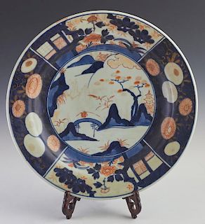 Imari Porcelain Charger, 19th c., the wide cobalt border with floral decoration around a central landscape reserve, the botto