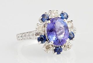 Lady's 14K White Gold Dinner Ring, with an oval 2.43 carat tanzanite atop a border of round white diamonds alternating with r