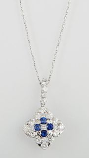 14K White Gold Diamond Shaped Pendant, with four central round blue sapphires atop a pierced border of round white diamonds, 
