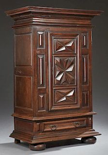 French Louis XIII Style Walnut Bonnetiere, 19th c., the stepped crown over a center door with three panels of applied geometr