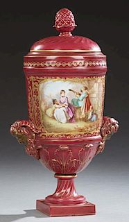 Sevres Style Porcelain Covered Urn, late 20th c., the lid with a gilt decorated pineapple finial over sides with pan head han