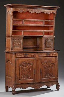 French Louis XV Style Carved Oak Vaisselier, 19th c., the rounded corner stepped ogee crown over two open plate racks over a 