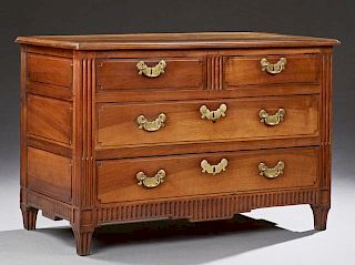 French Louis XVI Style Carved Walnut Commode, early 19th c., the stepped top over two frieze drawers above two deep drawers, 