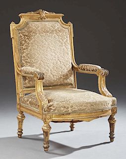 French Louis XVI Style Gilt and Gesso Fauteuil, 19th c., the stepped relief decorated crest rail over an upholstered back, to