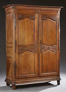 French Louis XV Style Provincial Carved Oak Armoire, 19th c., the rounded corner ogee crown over two double fielded panel doo