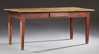 French Provincial Carved Cherry Table, 19th c., the rectangular plank top over a wide skirt with a single side drawer, on squ