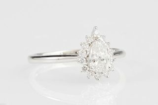 Lady's Platinum Dinner Ring, with a pear shaped .51 carat diamond atop a border of small round diamonds, diamond accent weigh