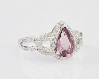 Lady's Platinum Dinner Ring, with a 1.57 carat pear shaped purple sapphire atop a conforming border of round diamonds, the pi