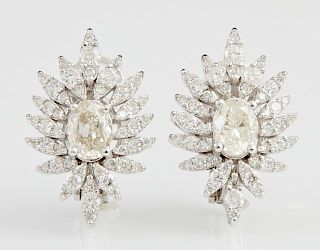 Pair of 14K White Gold Earrings, each with an oval .45 carat white diamond, within a floriform border of diamond mounted pear