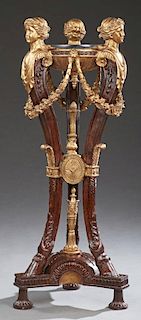 Classical Style Marble Top Gilt and Mahogany Pedestal, 20th c., the circular black marble top within three figural supports w