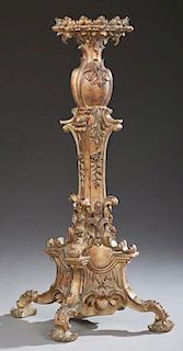 French Style Gilt Composition Pedestal, 20th c., the scalloped circular top on bulbous relief support to a tapered relief lea
