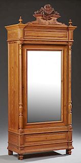 French Henri II Style Carved Pitch Pine Armoire, 19th c., the arched crown with a carved arched crest flanked by finials abov