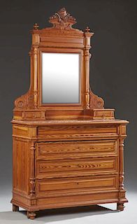 French Henri II Style Carved Pitch Pine Marble Top Dresser, 19th c., the arched carved crest flanked by finials over a bevele