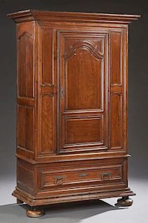 Louis XVI Style Carved Cherry Armoire, 19th c., the stepped crown over an arched fielded panel door, flanked by inset panels,