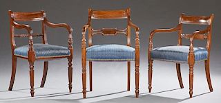 Group of Three English Carved Regency Armchairs, 19th c., one with a curved back over a pierced horizontal splat to curved ar