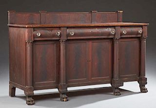 American Classical Revival Carved Mahogany Sideboard, 19th c., with a backsplash over a rectangular top over three drawers an