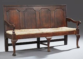 English Carved Oak Settee, 19th c., the rectangular back with three fielded panels, over loose upholstered seat cushion, flan