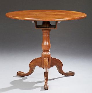 English Carved Mahogany Tilt Top Table, 19th c., the circular top and turned baluster support, with tripodal cabriole legs to