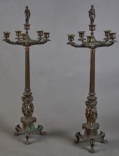 Pair of French Louis XVI Style Patinated Bronze Six Light Figural Candelabra, 19th c., the central candle cup with a figural 