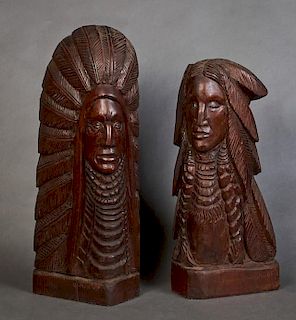 John Nelson (Canadian), "Indian with Feather Headdress," and "Indian Brave with Feathers and Braids," 1985, two wood carvings