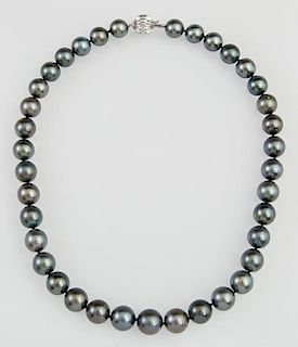Graduated Strand of Thirty-Seven Black South Seas Cultured Pearls, ranging from 10 mm to 12.5 mm, with a 14K white gold ball 