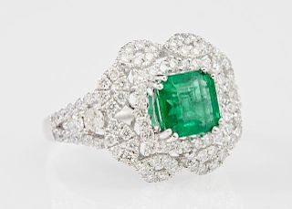 Lady's Platinum Dinner Ring, with a square 1.68 carats emerald, atop a shaped border of round diamonds, within a border of pi