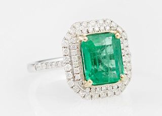 Lady's 14K White Gold Dinner Ring, with a 3.41 carats emerald atop an octagonal double concentric graduated border of small r