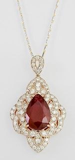 14K Yellow Gold Pendant, with a pear shaped 11.98 carats ruby, within a pierced floriform diamond mounted bezel, with a diamo