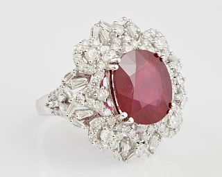 Lady's 14K White Gold Dinner Ring, with an oval 8.08 carats ruby within an elaborate pierced border mounted with round and ba