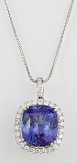 Platinum Pendant Earrings, with a cushion cut 32.24 carats tanzanite, atop a border of round diamonds with a diamond mounted 