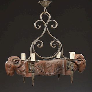 Unusual French Provincial Louis XVI Style Carved Walnut and Wrought Iron Four Light Chandelier, 20th c., with a scrolled iron
